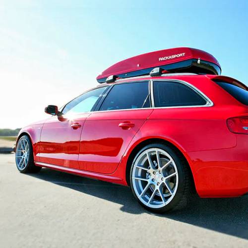 Red and black rooftop cargo box on modern station wagon